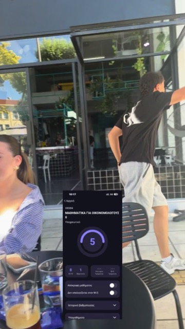 Student at a café with his grade open in UniStudents
